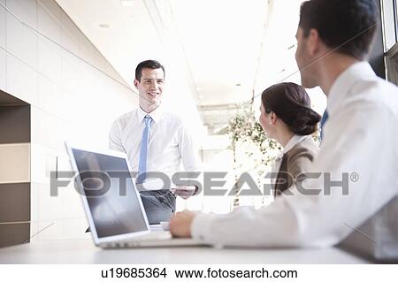 Picture - Presentation with young business team. Fotosearch
