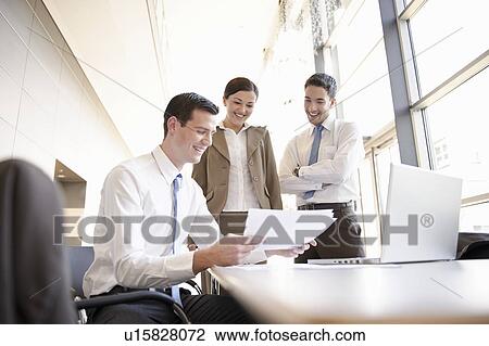 Stock Image - Presentation with young business team. Fotosearch
