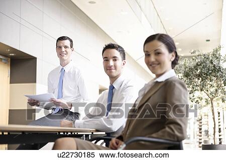 Stock Photography - Presentation with young business team. Fotosearch