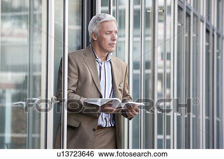 Stock Photograph - Reading outside the office. Fotosearch