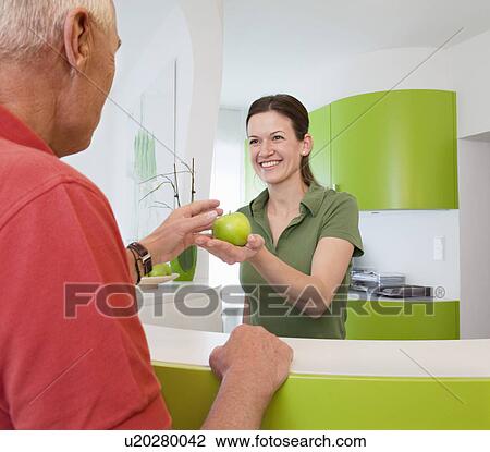 Stock Image - Receptionist with patient in surgery. Fotosearch