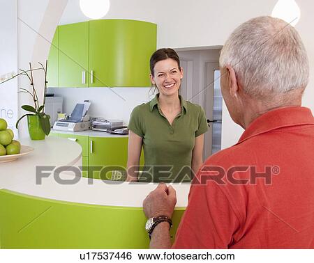 Receptionist with patient in surgery View Large Photo Image Stock Photograph - Receptionist with patient in surgery. Fotosearch