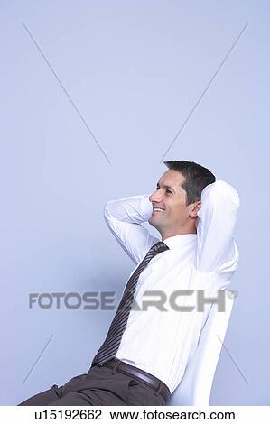 relaxed businessman sitting and smiling View Large Photo Image Stock Image - relaxed businessman sitting and smiling . Fotosearch