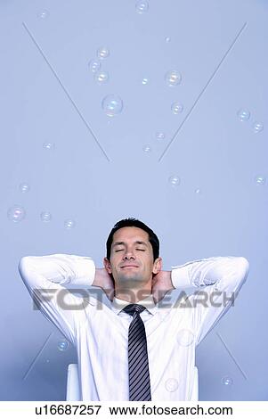 relaxed businessman sitting with bubbles View Large Photo Image Stock Photo - relaxed businessman sitting with bubbles. Fotosearch