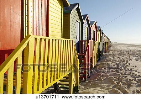 Row of colorful beach huts on beach View Large Photo Image Stock Image - Row of colorful beach huts on beach. Fotosearch