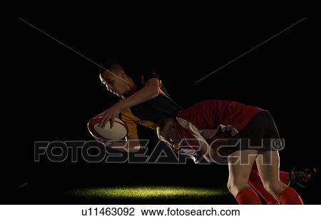 Rugby player being tackled View Large Photo Image Stock Image - Rugby player being tackled. Fotosearch