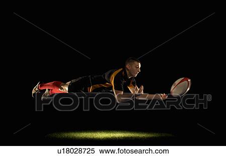 Rugby player diving and passing View Large Photo Image Stock Photography - Rugby player diving and passing. Fotosearch