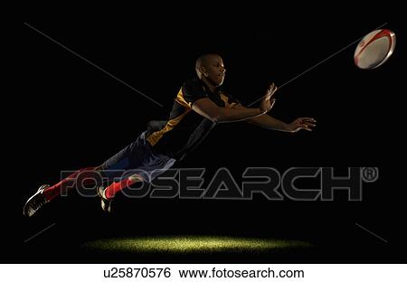 Rugby player diving whilst passing ball View Large Photo Image Stock Photograph - Rugby player diving whilst passing ball. Fotosearch