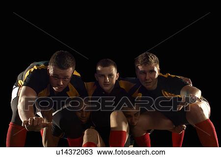 Stock Image - Rugby players in scrum formation. Fotosearch