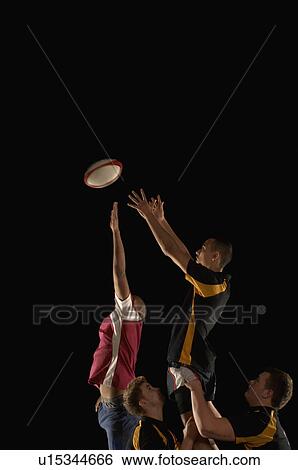 Stock Photograph - Rugby players jumping for ball. Fotosearch