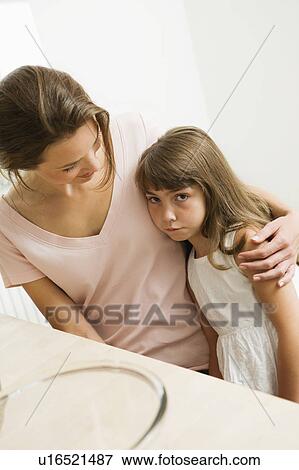 Sad little girl with her mother View Large Photo Image Stock Photo - Sad little girl with her mother. Fotosearch