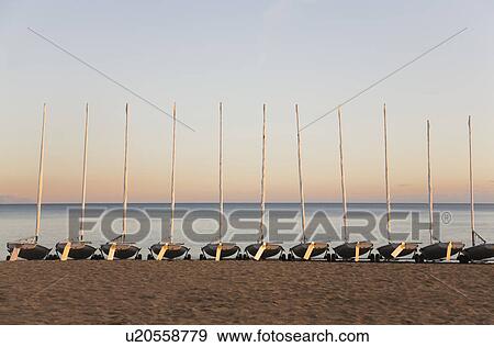Sail boats on a beach View Large Photo Image Stock Photo - Sail boats on a beach. Fotosearch