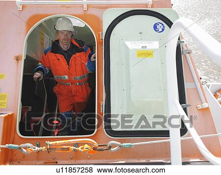 Stock Photo - Sailor ascending stairs to hatch. Fotosearch