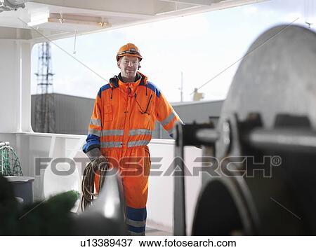 Sailor holding rope on deck View Large Photo Image Stock Photo - Sailor holding rope on deck. Fotosearch