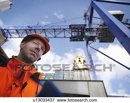 Sailor inspects cargo under gantry crane View Large Photo Image Stock Photo - Sailor inspects cargo under gantry crane. Fotosearch