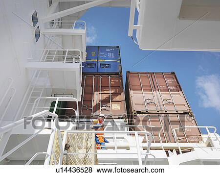 Stock Photo - Sailor waking in cargo area. Fotosearch
