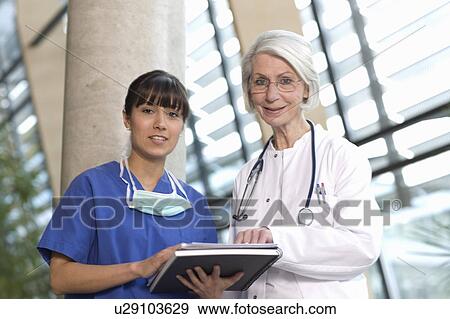 Scrub nurse and woman doctor View Large Photo Image Stock Photo - Scrub nurse and woman doctor. Fotosearch