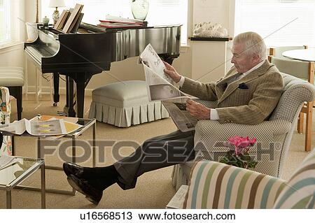 Stock Image - Senior man reading newspaper. Fotosearch