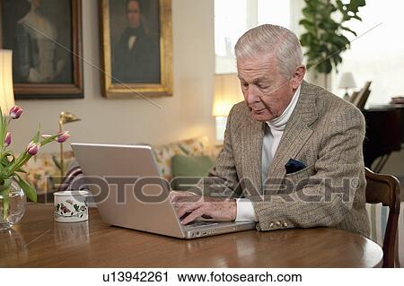 Senior man working on computer View Large Photo Image Stock Image - Senior man working on computer. Fotosearch