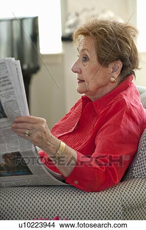 Senior woman reading newspaper View Large Photo Image Picture - Senior woman reading newspaper. Fotosearch