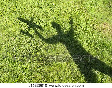 Shadow of a woman holding an rc plane View Large Photo Image Stock Image - Shadow of a woman holding an rc plane. Fotosearch