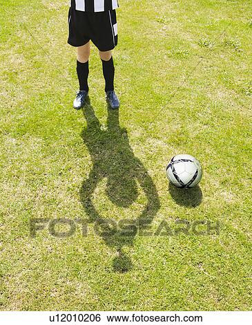 Stock Photograph - Shadow of Boy with Trophy. Fotosearch