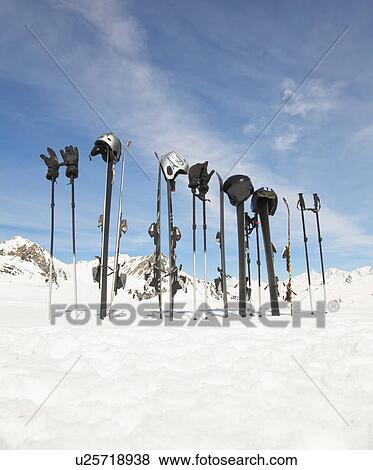 Stock Photo - Ski equipment in snowy mountain scene. Fotosearch