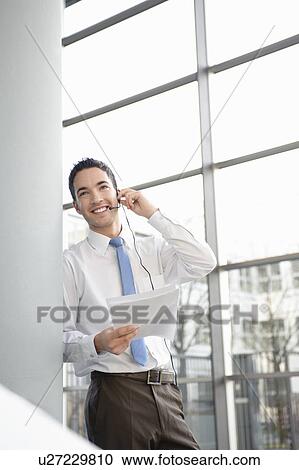 Smiling business man in office, headset View Large Photo Image Stock Image - Smiling business man in office, headset. Fotosearch