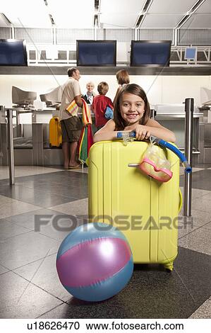 Smiling girl in front of a checkin desk View Large Photo Image Stock Image - Smiling girl in front of a checkin desk. Fotosearch