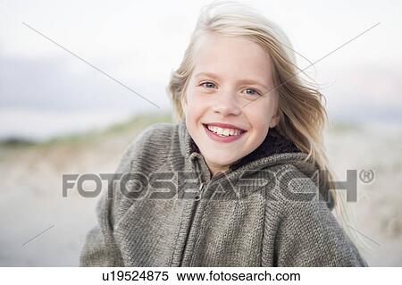 Stock Photography - Smiling girl on beach. Fotosearch