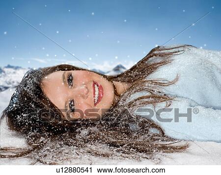 Smiling woman lays in snow portrait View Large Photo Image Stock Image - Smiling woman lays in snow portrait. Fotosearch