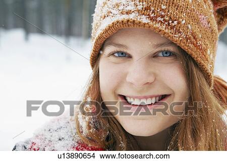 Smiling young woman in snow View Large Photo Image Picture - Smiling young woman in snow. Fotosearch