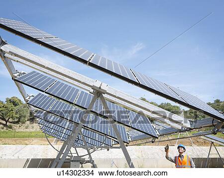 Picture - Spanish solar power station with worker. Fotosearch