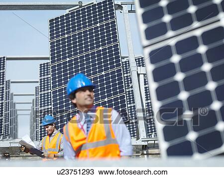 Stock Image - Spanish solar power station with workers. Fotosearch