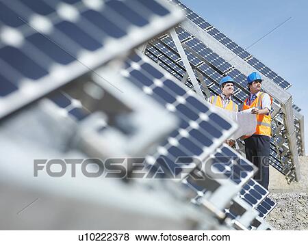 Stock Photo - Spanish solar power station with workers. Fotosearch