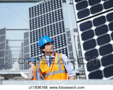 Stock Photo - Spanish solar power station with workers. Fotosearch