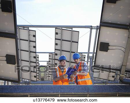Stock Photo - Spanish solar power station with workers. Fotosearch