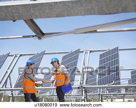 Stock Photo - Spanish solar power station with workers. Fotosearch