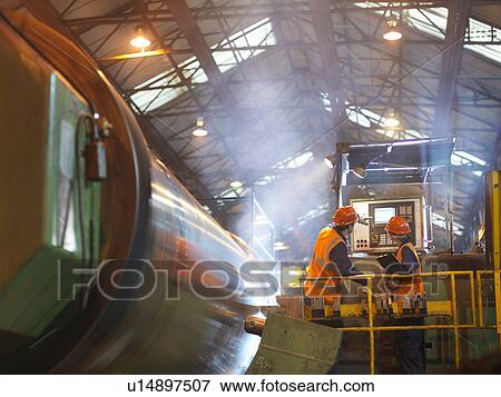 Stock Photo - Steel Engineers At Lathe Control Panel. Fotosearch