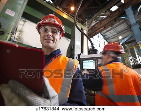 Picture - Steel Engineers In Plant With Clipboard. Fotosearch