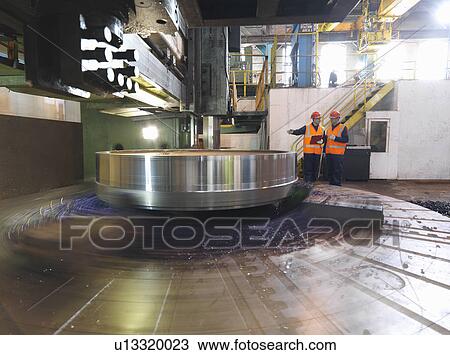 Stock Image - Steel Engineers With Lathe. Fotosearch