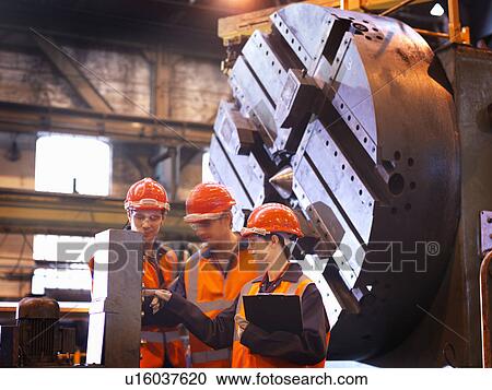 Stock Image - Steel Engineers With Lathe. Fotosearch