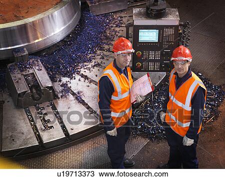 Stock Image - Steel Engineers With Lathe. Fotosearch