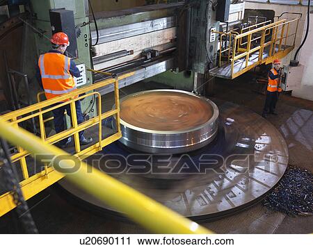 Stock Image - Steel Engineers With Lathe. Fotosearch