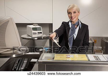 Stewardess handing travel ticket View Large Photo Image Stock Image - Stewardess handing travel ticket. Fotosearch