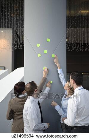 Team brainstorming with sticky notes View Large Photo Image Picture - Team brainstorming with sticky notes. Fotosearch
