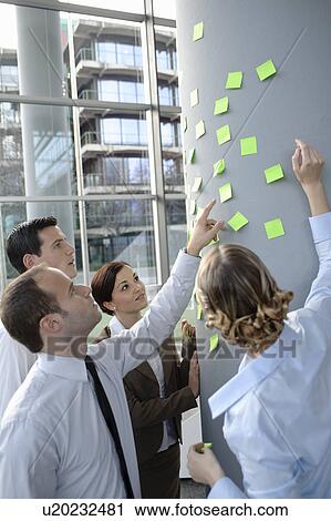 Stock Image - Team brainstorming with sticky notes. Fotosearch