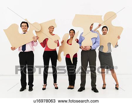 Team hold jigsaw pieces View Large Photo Image Stock Image - Team hold jigsaw pieces. Fotosearch