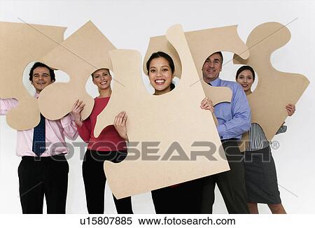 Team hold jigsaw pieces View Large Photo Image Stock Photography - Team hold jigsaw pieces. Fotosearch