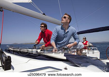 Team setting sail on yacht View Large Photo Image Stock Photo - Team setting sail on yacht. Fotosearch